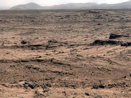 　米航空宇宙局（NASA）の探査機「Curiosity」は、火星の最初の掘削場所から、火星の土壌サンプルを初めて採集した。NASAはまだ有機化合物を発見していないものの、水や硫黄、塩素などの物質を含む化合物を検出している。

　Curiosityは土壌をすくい取って分析装置に入れることのできる初めての火星探査機だ。そして同探査機に岩石サンプルを分析する科学的能力があることは、テストによって証明されている。この分析作業は今後2年間続く見通しだ。これらの最初の試料は、「Rocknest」と呼ばれる、風に吹かれた塵と砂の吹きだまり（上の写真を参照）から採集された。Rocknestはゲイルクレーターの内側にあり、シャープ山と呼ばれる山の斜面にある同探査機の主たる目的地からは依然として何マイルも離れている。

　「Sample Analysis at Mars（SAM）」装置一式と「Chemistry and Mineralogy（CheMin）」装置は、小型炉で熱したサンプルが発する気体を分析し、その混合物の約半分が一般的な火山性の鉱物で、残りの半分がガラスのような非結晶質の物質であることを発見した。SAMは、かなりの低濃度で存在する成分やアイソトープの比率についての情報も追加した。これらの情報は、環境の変化に関する手がかりを提供する可能性がある。
