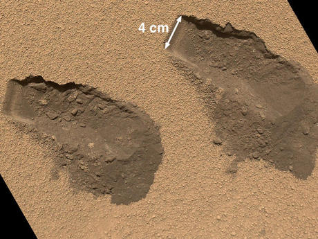 　12月までに、Curiosityは火星で最初に採取した土壌サンプル群の分析を終えた。この写真には、同探査機が探査中にスコップで掘った2つの穴が写っている。NASAは火星の土壌内に複雑な化合物を発見したと述べている。Curiosityのアームが同探査機内の火星サンプル分析装置（SAM）に取り込んだサンプルからは、水や硫黄、塩素などの物質を含む化合物が検出されている。
