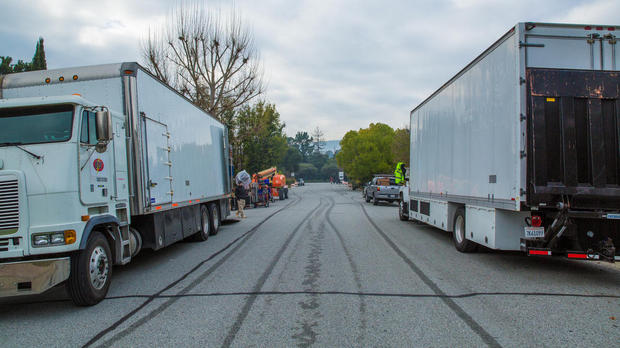 トラックが並んだ通り

　16日、Appleが誕生した家の前の道路には、機材などが満載されたトラックが止められていた。