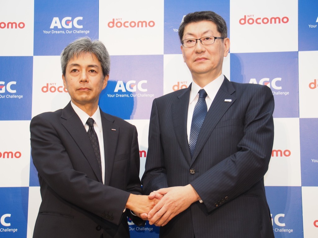NTTドコモはAGCと提携し、基地局用のガラスアンテナの開発を発表。写真は説明会に登壇した、NTTドコモの無線アクセスネットワーク部長である小林宏氏と、AGCのビルディング・産業ガラスカンパニーのアジア本部長である武田雅宏氏
