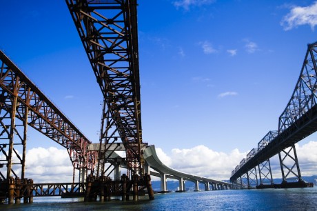 　Googleとカリフォルニア州運輸局（Caltrans）は先週、建設中の新Bay Bridgeを「Google Earth」に組み込む提携を発表した。この橋は、Google Earthでマッピングされ、工事中と完成済の部分が表示されるようになる。2002年に着工され、2013年に完成予定となっている。

　われわれは、Google Earthの中心人物の1人であるMichael Jones氏とサンフランシスコ湾の建設現場へ赴き、実際の様子を確認した。

　Bay Bridge（左）の建設が進むにつれて、Google Earthユーザーは開発の進ちょくに対するライブアップデートを得られる。
