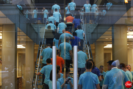 　サンフランシスコのApple Store店内。店員が青とオレンジのシャツを着て、午前7時の開店に備えている。