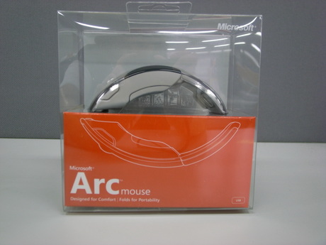 　10月10日に発売開始したばかりの「Microsoft Arc Mouse（マイクロソフト アーク マウス）」。細身のデザインで、コンパクトに折りたためる今までのマイクロソフトにはないデザインだ。さっそくパッケージから見ていこう。
　Arc Mouseのデザインを全面的に見せるため、これまでよりも透明感のあるパッケージになっている。横からもArc Mouseがきれいに見える。