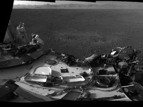 　NASAの探査機Curiosityは、火星のゲイルクレーターの中から、前ページにある360度の高解像度イメージを送ってきた（この画像はその一部）。前ページの画像は、延長されたマストに搭載されたナビゲーションカメラで撮影されており、マストの影が画像の中央付近に見え、左にはゲイルクレーターのリム、中央右にはシャープ山の麓が見える。