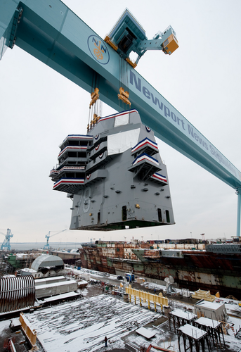 　2013年1月26日、ニューポートニューズ造船所の「Big Blue」クレーン（最大1050トンの荷をつり上げ可能）がGerald R. Fordの艦橋をつり上げて、飛行甲板に下ろす準備をしている。