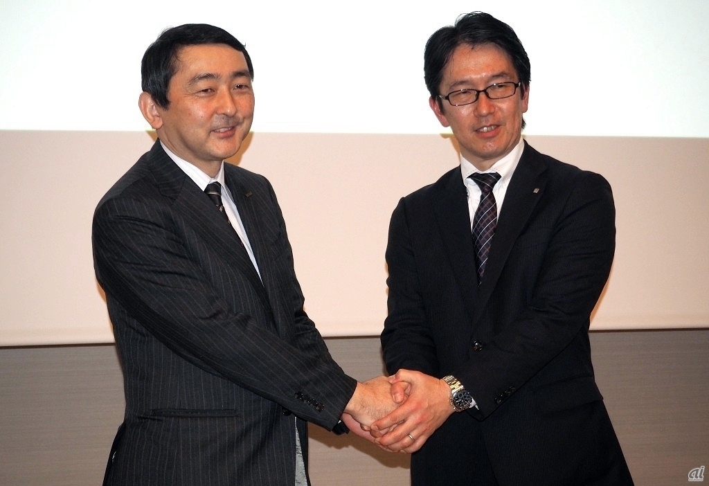 5Gの技術実証による提携で握手を交わす、KDDIの松永氏とセコムの寺本氏