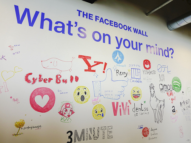 　スタッフや来社した人が自由に書き込める「Write something wall（通称：Facebook Wall）」。ネット企業やメディアなどいろいろなロゴが描かれていた。