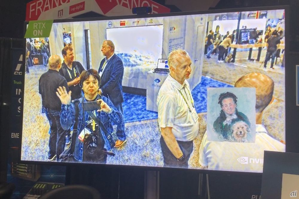 モニター右下の画風を真似てリアルタイムで写真を加工するサービスも人気を集めていた。画面内で手を振っているのが筆者。
