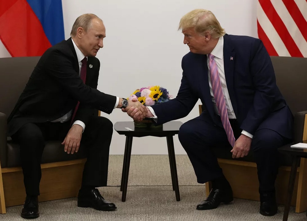 US President Donald Trump greets Russian President Vladimir Putin
