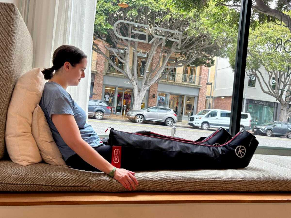 足全体を覆うブーツを着け、足を伸ばしてくつろぐ筆者<br>提供：Anna Gragert/CNET